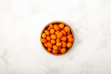 Coated Peanut in ceramic bowl, top view. Delicious crispy peanut. Turkish snack