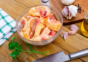 Wall Mural - Chopped uncooked chicken and condiments on kitchen table. Preparing food at home.