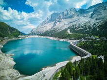 Extreme Long Shot Of The Fedaia Pass, Over Fedaia Lake, Dolomites, And The Marmolada Glacier