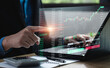 © Sutthiphong - Businessman uses laptop to analyze stock market for cryptocurrencies and economic growth charts. forex trading digital assets stock market chart numbers, business finance technology