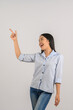 © Johnstocker - Portrait of young asian woman pointing with two hands and fingers to the side over isolated white background