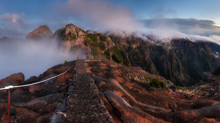 Sticker - Landscape of sunrise in mountain over clouds in Madeira Island on Pico do Arieiro over steep cliffs and high peaks with the morning mist  in central Madeira. Portugal