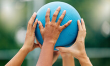Netball, Hands And Woman Holding A Ball During A Game For Support, Teamwork Or Training Together. Sports, Community And Collaboration For A Team Of Athlete People At A Sport Event With Solidarity