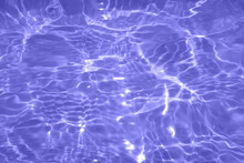 Defocus Blurred Transparent Purple Colored Clear Calm Water Surface Texture With Splash, Bubble. Shining Purple Water Ripple Background. Surface Of Water In Swimming Pool. Purple Bubble Water Shine.