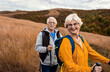 © Zoran Zeremski - Portrait of active senior couple with backpacks hiking together in nature on autumn day.