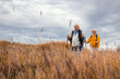 © Zoran Zeremski - Active senior couple with backpacks hiking together in nature on autumn day.