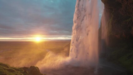 Wall Mural - Beautiful Seljalandsfoss waterfall flowing and midnight sunset shining on summer at South of Iceland