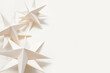 Merry Christmas.Christmas stars handmade light beige background.Monochrome,Christmas background,holiday card.DIY christmas flat lay copy space.Christmas zero waste, paper, eco postcard