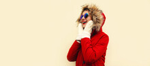 Portrait Of Happy Surprised Laughing Young Woman Wearing Red Jacket With Fur Hood And Mittens