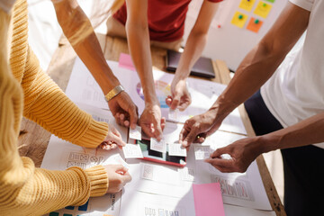 Wall Mural - a ux design team is a confluence of user research, ux, ui design with layout paper on desk.