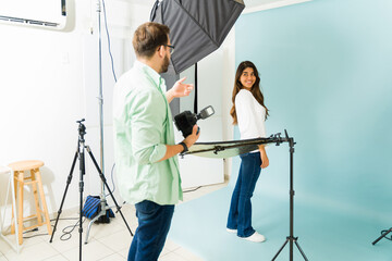 Happy model talking with a photographer at the studio