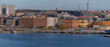 Panorama view from the mountain Skinnarviksberget, down town buildings, the island Riddarholmen, piers with boats and bridges with commuter trains a sunny autumn day in Stockholm