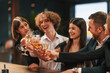 © standret - Sitting together. Group of people in elegant clothes are in the restaurant celebrating event