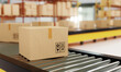© Shutter2U - Close-up of cardboard boxes on roller conveyor with storage warehouse background. Business logistics and E-commerce transportation concept. 3D illustration rendering