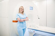© Oleksandr - Blonde medical specialist in blue uniform near MRI scanner