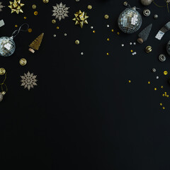 Wall Mural - Luxury Christmas, New Year holidays composition with blank copy space. Gold baubles balls, stars on black background. Christmas tree decorations. Flat lay, top view festive template