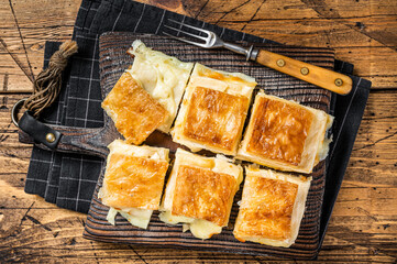 Delicious Turkish Tray pastry, Su boregi with cheese. Wooden background. Top view