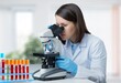 © BillionPhotos.com - Young doctor with sample tube and microscope in lab