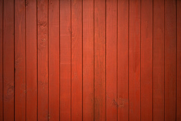 Wall Mural - Red wooden background made of boards. Siding on the wall of the house. The texture of the wooden lining painted with red paint.