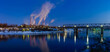 Industrial winter panorama with a factory, pipes and a railway bridge