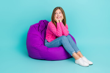 Poster - Full length photo of positive lovely lady sit comfort chair look empty space banner news information isolated on cyan color background