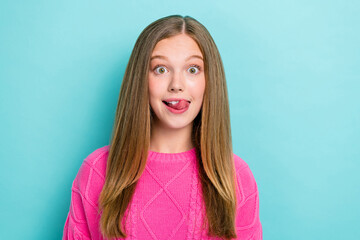 Wall Mural - Photo of positive cheerful impressed girl straight hairstyle wear pink knit sweater tongue lick teeth isolated on blue color background