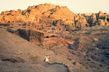 Female Caucasian Tourists Walk Around The Petra Ruins With Famous Al-Khazneh (The Treasury).