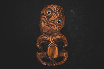 Wall Mural - Wooden Maori Hei Tiki hand carved with paua shell eyes. New Zealand taonga.