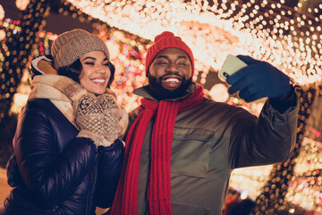 Poster - Photo of pretty cheerful husband wife wear winter season clothes video call xmas market outside urban city street