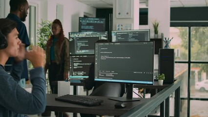 Software developer programming source code algorithm on computer, typing sever data in agency office. Database programer working on new user interface with online system to create algorithm.