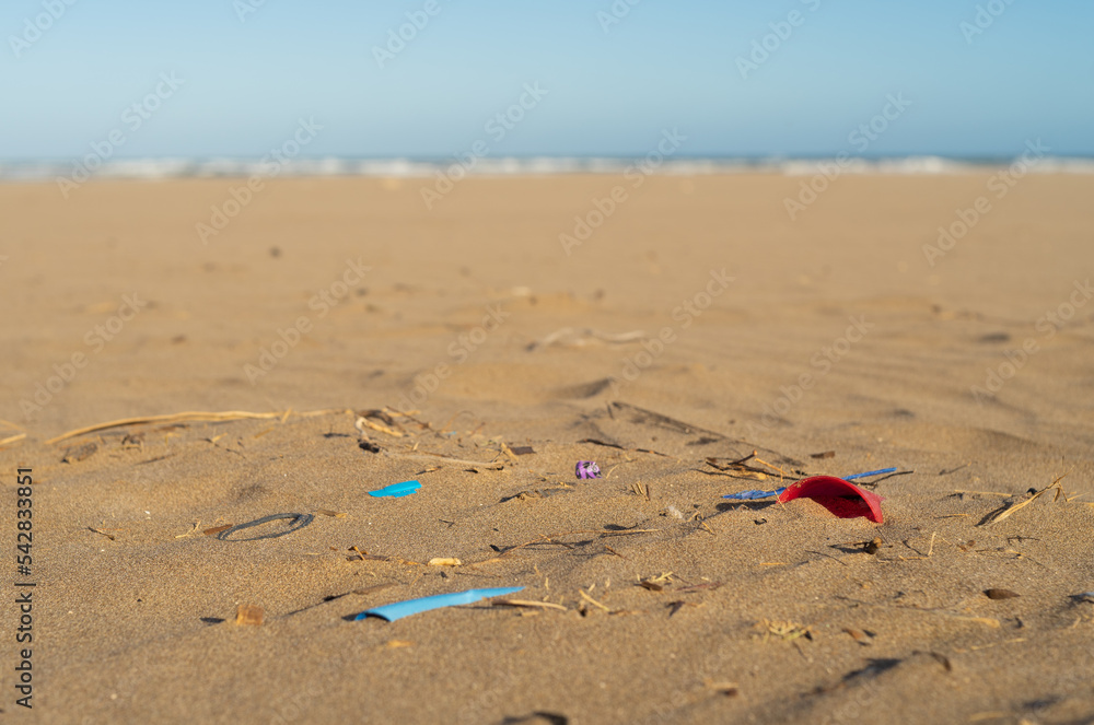 beach with garbage contamination, plastics, bags and cigarette butts ...