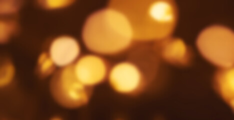 Christmas golden lights Background. Abstract twinkled bright bokeh defocused lights.