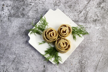 Wall Mural - Manti steamed Dumplings with meat and potatoes on a white square  plate on a dark background. Top view, flat lay