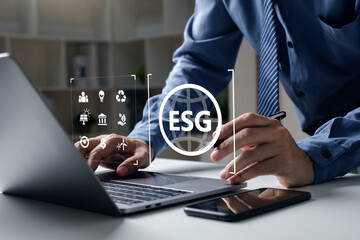 Young business pointing to ESG icon for Environmental Social and Governance, Sustainable environment concept.