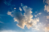 Fototapeta Natura - White fluffy cumulonimbus storm clouds in deep blue sky