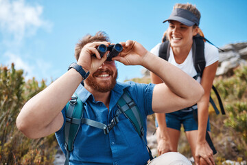 Canvas Print - Hiking, nature and couple with binoculars, happy, smile and relax while watching, looking and explore together. Friends, freedom and hikers bond by woman and man laugh, search and enjoy scenic view