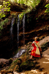 Wall Mural - a girl in Chuvash national dress and the waterfall 