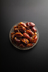 Wall Mural - Dates fruit on dark background with copy spaces. Arabian fruit