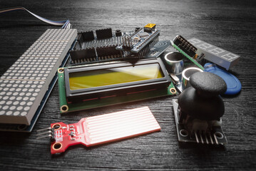 Wall Mural - microprocessor programming parts on the black table concept background.