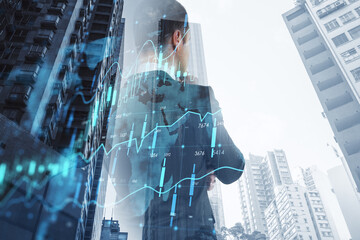 Canvas Print - Global market economy concept with digital financial chart indicators graphs on pensive man back view and skyscrapers perspective view, double exposure