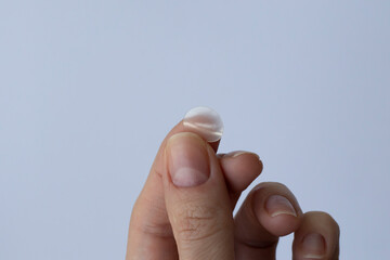 round pimple patch in a woman's hand on a white background. pimple patches for facial cleansing