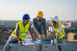 © NDABCREATIVITY - Business, teamwork and people concept. Group of engineers and architects on construction site