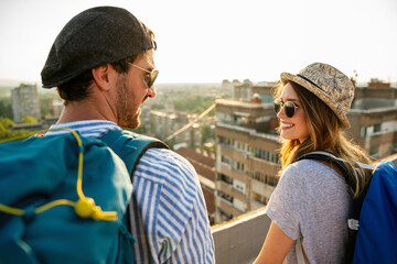 Happy couple on vacation sightseeing city with map. People travel fun honeymoon concept.