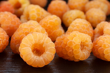 Wall Mural - Yellow raspberry berries on black