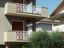 Exterior Of Residential Building With Balconies On Sunny Day