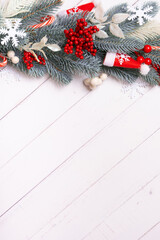 Wall Mural - Christmas vertical background made from pine tree, snowflakes and festive decorations top view. Christmas flat lay