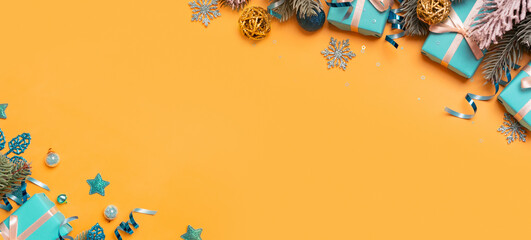 Wall Mural - christmas banner background with pine tree, gifts and festive decorations top view. christmas flat l