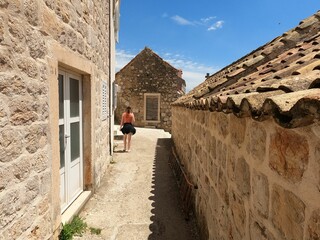 Wall Mural - Landscape of the medieval buildings at Sipan Island shore in Croatia on a sunny day