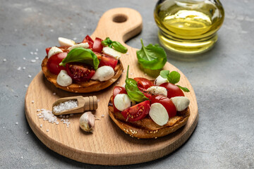 Canvas Print - Open sandwiches with cherry tomatoes, mini mozzarella, fresh basil leaves, caprese on bread, Traditional italian appetizer or snack, antipasto. banner, menu, recipe place for text, top view