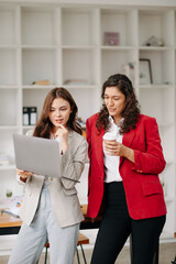 Wall Mural - Business colleague business presents and explains and using laptop and tablet. Teamwork, financial marketing team, while sitting in office